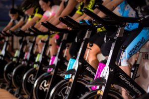 Several people riding stationary bikes to help fight ageing process