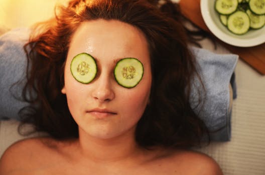 Girl are skin clinics Glasgow with lotion and cucumbers on her face